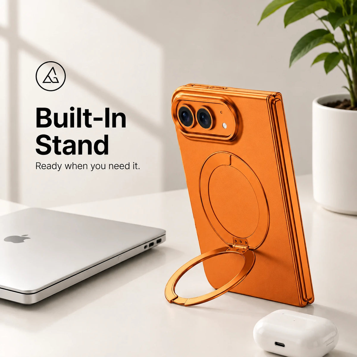 Orange folding phone case standing upright with its circular built-in stand on a desk #color_Cosmic Orange