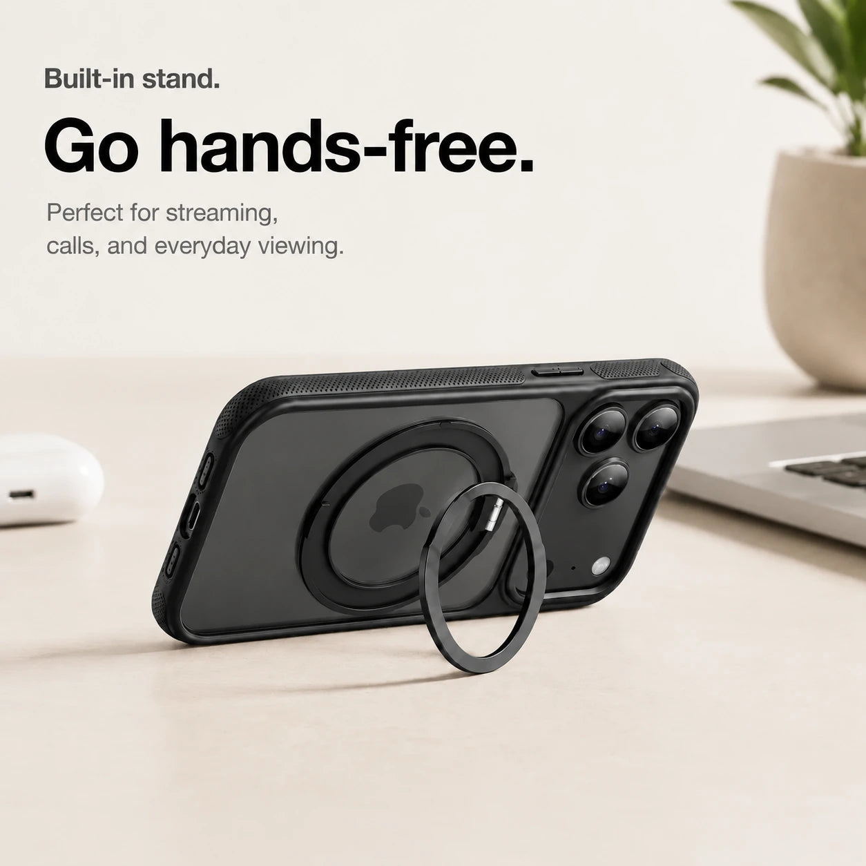 Black magnetic phone case propped horizontally on its ring stand beside a laptop #color_Midnight Black