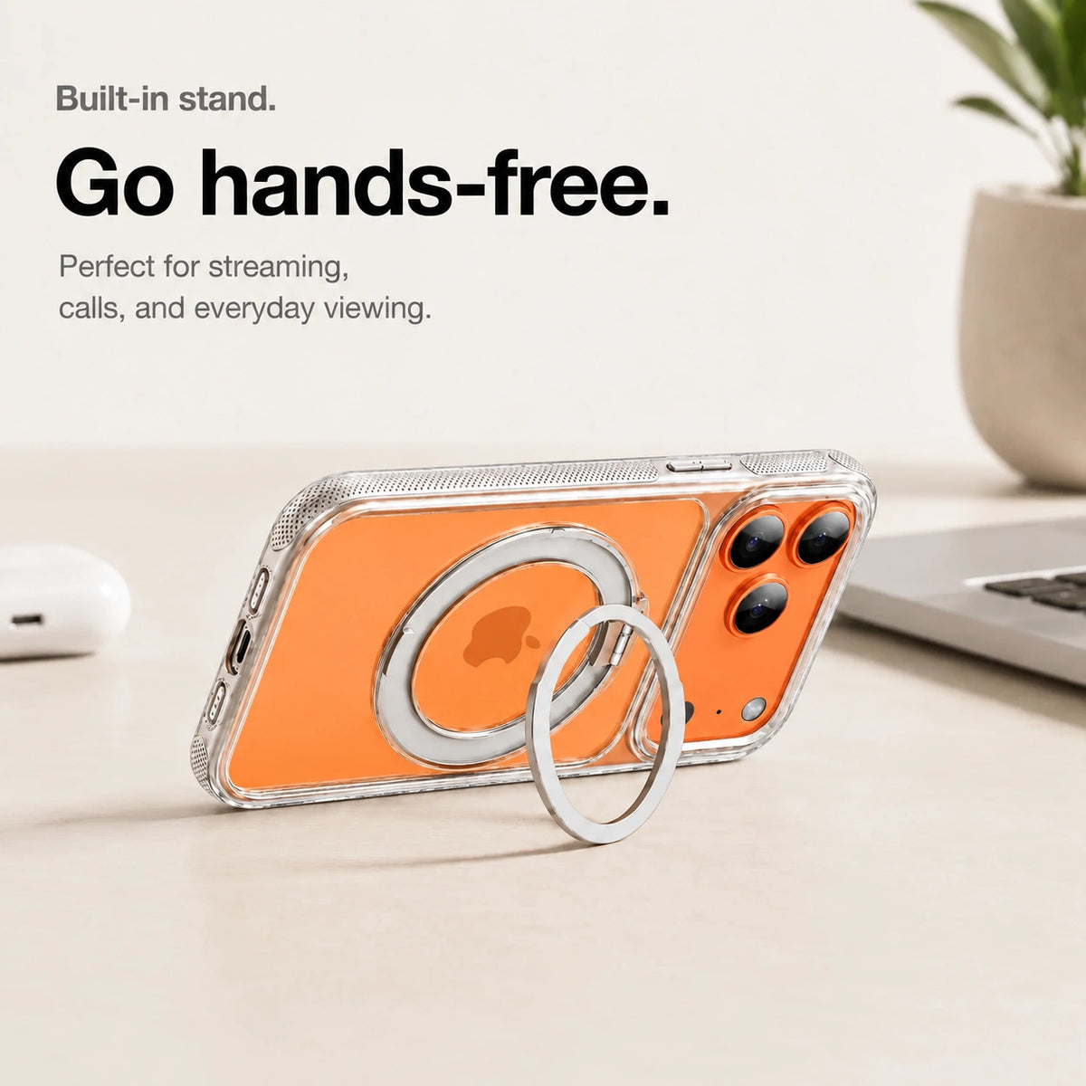 Clear magnetic phone case propped horizontally on its ring stand beside a laptop #color_Transparent