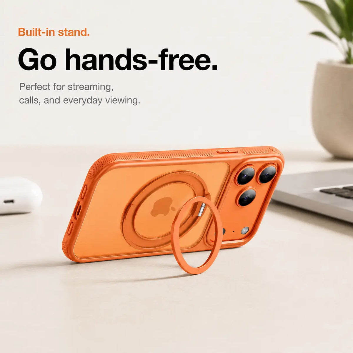 Orange magnetic phone case propped horizontally on its ring stand beside a laptop #color_Cosmic Orange