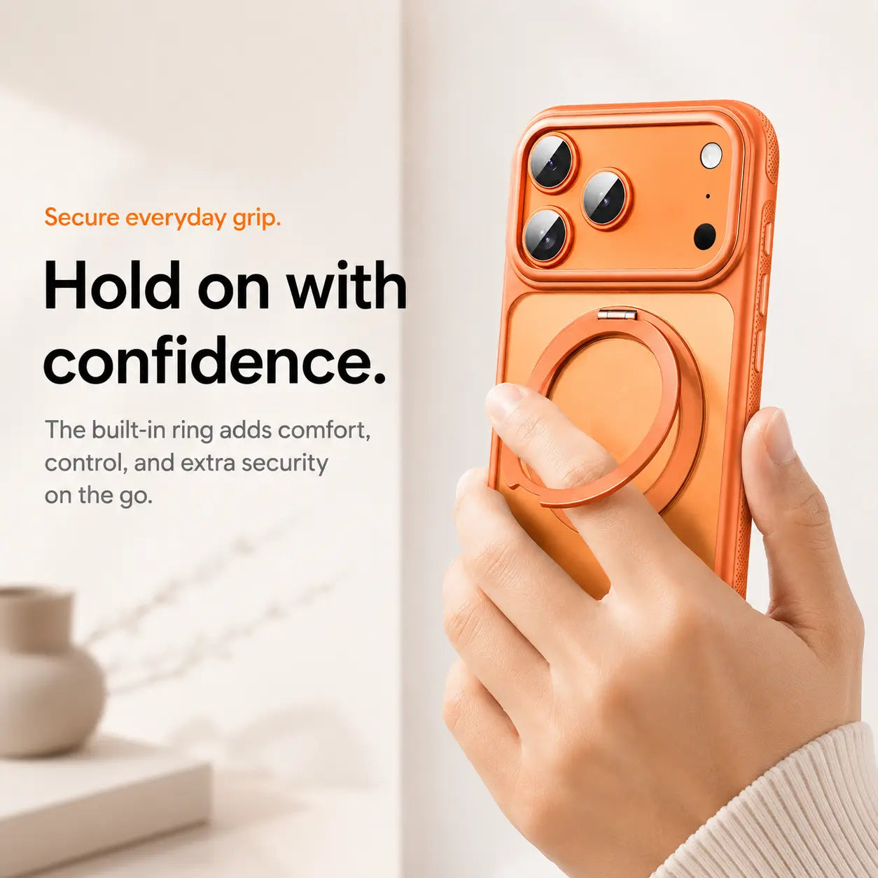 Orange magnetic phone case held with a finger through the adjustable ring grip #color_Cosmic Orange